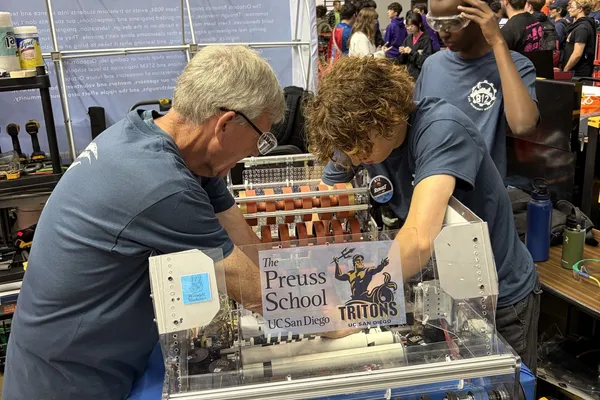 Mentor and students calibrating the shooter mechanism